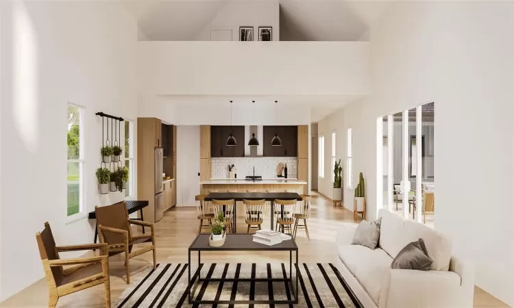 Living room with a high ceiling and light hardwood / wood-style flooring