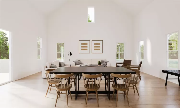 Dining space featuring a high ceiling and light hardwood / wood-style flooring