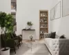 Sitting room featuring built in shelves and hardwood / wood-style flooring