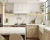 Kitchen featuring wall oven, tasteful backsplash, luxury range, sink, and light brown cabinets