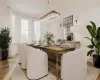 Dining area with a healthy amount of sunlight and light hardwood / wood-style flooring