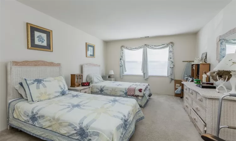 Bedroom with light carpet