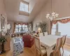 Dining room featuring a chandelier, a high ceiling, and light wood-type flooring