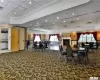 Carpeted dining space featuring a raised ceiling and crown molding