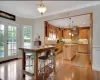 Kitchen featuring a center island, french doors, hanging light fixtures, light hardwood flooring, and tasteful backsplash