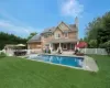 Rear view of house with a yard, a patio, and french doors