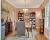 Dining room with a notable chandelier, ornamental molding, and light hardwood / wood-style flooring