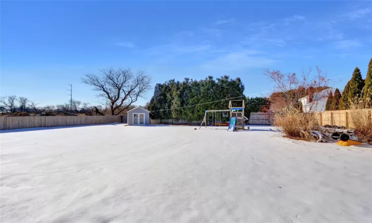 View of yard with a shed and a playground