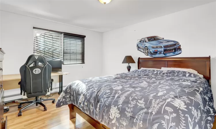 Bedroom with hardwood / wood-style flooring