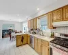 Kitchen featuring stainless steel appliances, sink, a wealth of natural light, and kitchen peninsula