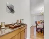 Bar featuring a baseboard heating unit, light hardwood / wood-style floors, and a chandelier