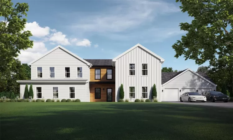 View of front of property with a garage and a front lawn