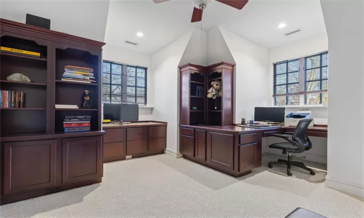 Office space with ceiling fan, plenty of natural light, and light carpet