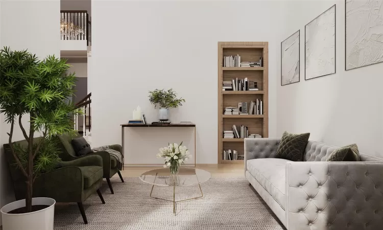 Sitting room with built in shelves and hardwood / wood-style floors