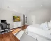 Bedroom featuring vaulted ceiling and wood-type flooring