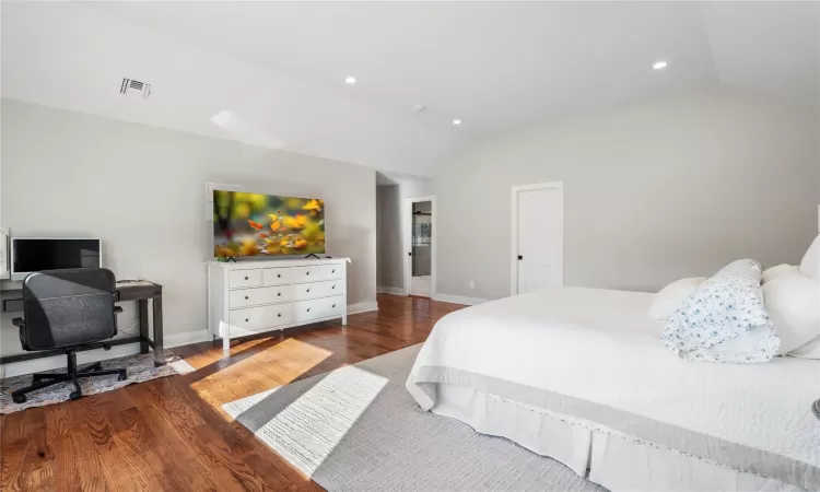 Bedroom featuring vaulted ceiling and wood-type flooring