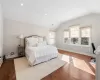 Bedroom with hardwood / wood-style flooring and vaulted ceiling