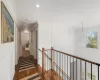 Hall with dark hardwood / wood-style flooring, ornamental molding, and a notable chandelier