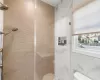 Bathroom featuring toilet and tiled shower