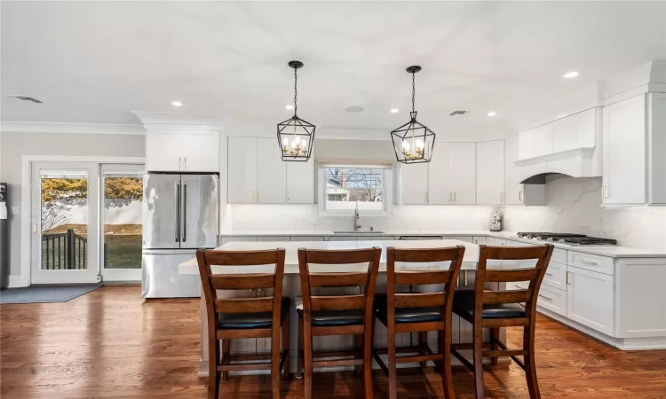 Kitchen featuring sink, white cabinetry, a center island, and appliances with stainless steel finishes