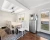 Dining area featuring a tray ceiling, a healthy amount of sunlight, and dark hardwood / wood-style floors