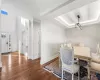 Dining space with dark wood-type flooring and a tray ceiling