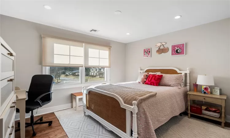 Bedroom with light hardwood / wood-style flooring