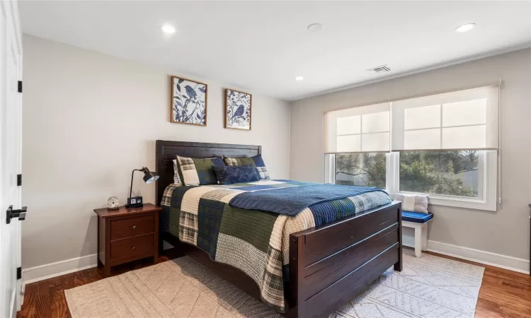 Bedroom with hardwood / wood-style flooring