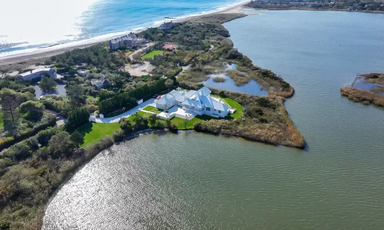 Drone / aerial view with a water view and a beach view