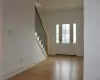 Unfurnished living room featuring a fireplace, crown molding, and light hardwood / wood-style flooring