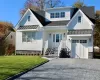 View of front of home with a garage and a front lawn