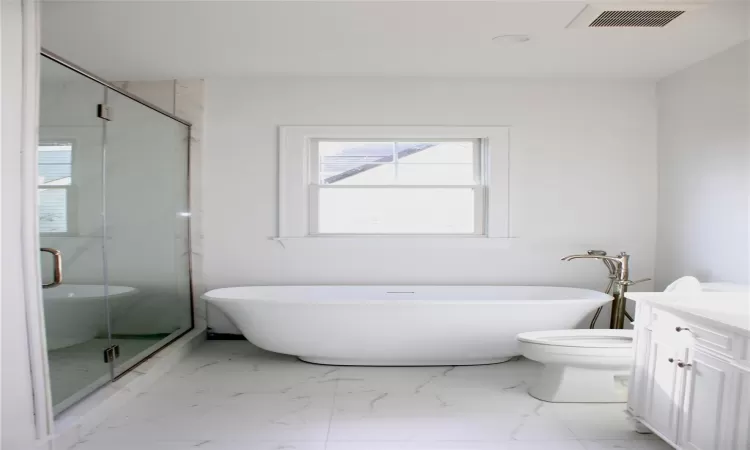 Full bathroom featuring vanity, independent shower and bath, and toilet