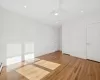 Empty room with light hardwood / wood-style floors, ceiling fan, and a baseboard heating unit