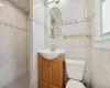 Bathroom with vanity, toilet, and walk in shower