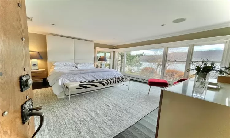 Bedroom with wood-type flooring and crown molding