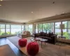 Living room featuring plenty of natural light, light hardwood / wood-style flooring, and a baseboard radiator