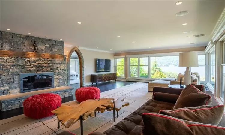 Living room featuring a fireplace and ornamental molding