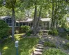 View of front of home with a sunroom and a front lawn