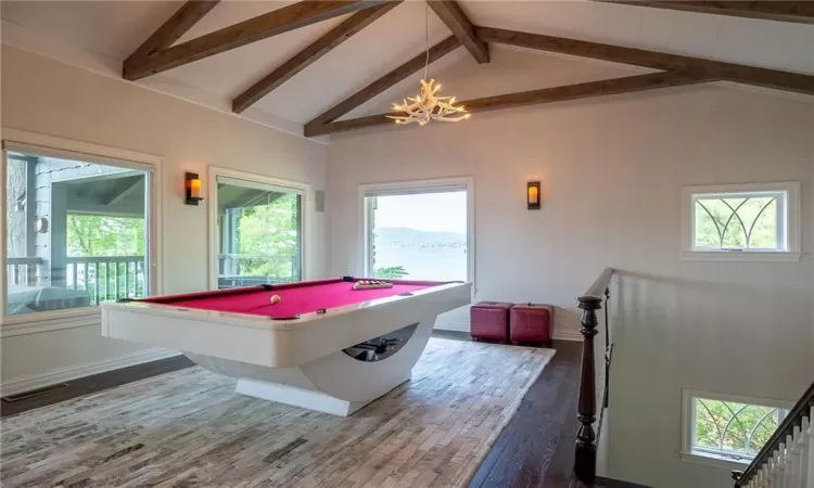 Rec room featuring hardwood / wood-style floors, lofted ceiling with beams, billiards, and a notable chandelier