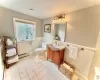 Bathroom with tile patterned floors, vanity, toilet, and a baseboard heating unit