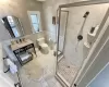 Bathroom with vanity, an enclosed shower, tile walls, and toilet