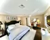 Bedroom featuring crown molding and dark wood-type flooring