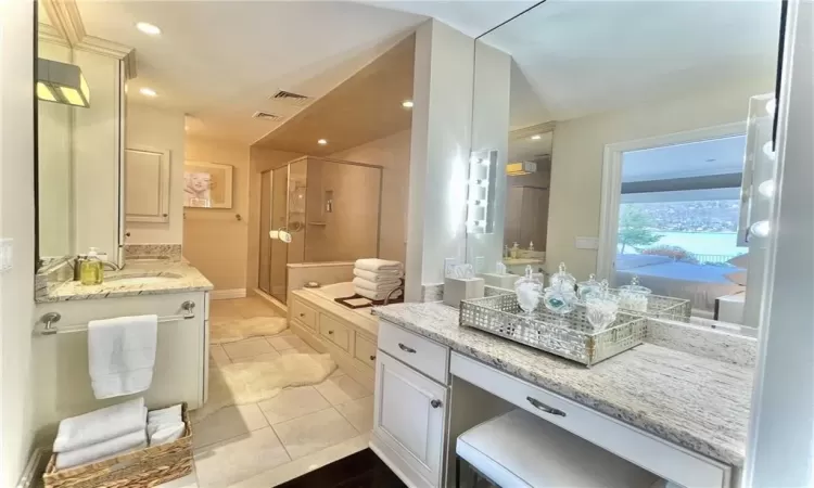 Bathroom with tile patterned flooring, vanity, and an enclosed shower