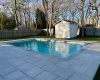 View of swimming pool with a shed