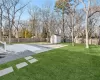 View of yard featuring a patio and a storage unit