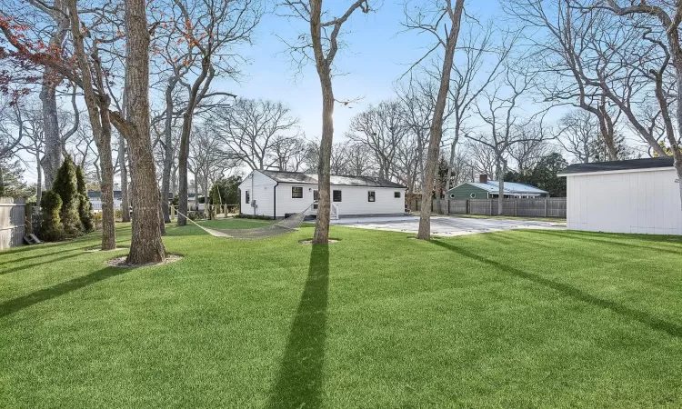 View of yard featuring an outdoor structure and a patio