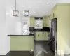 Kitchen with stainless steel appliances, hanging light fixtures, dark hardwood / wood-style flooring, sink, and backsplash