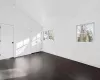 Primary bedroom featuring lofted ceiling, wood ceiling, and dark hardwood / wood-style flooring