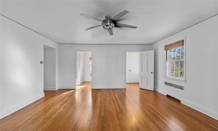 Unfurnished room with ceiling fan and light hardwood / wood-style floors