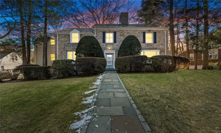 View of front of home with a lawn and a garage